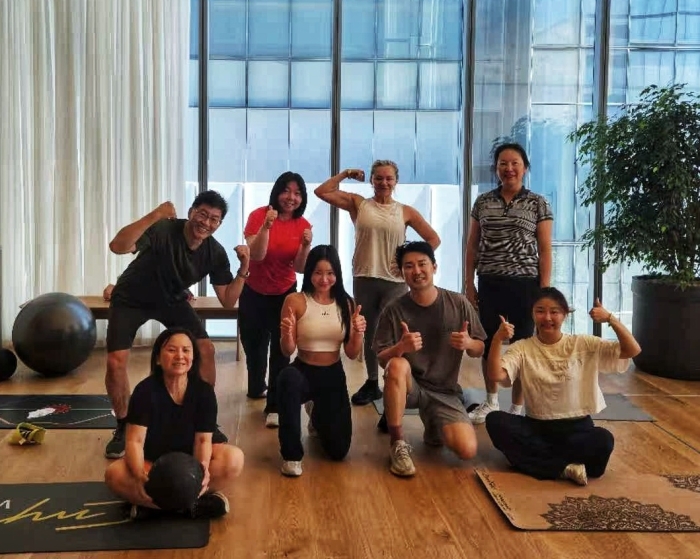 Eva Lee's Body Strong group class together after a session in a light-filled studio