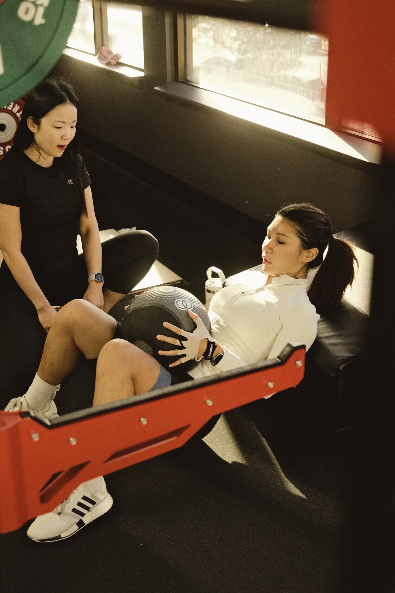 Eva Lee coaching a private client through core work in warm morning light